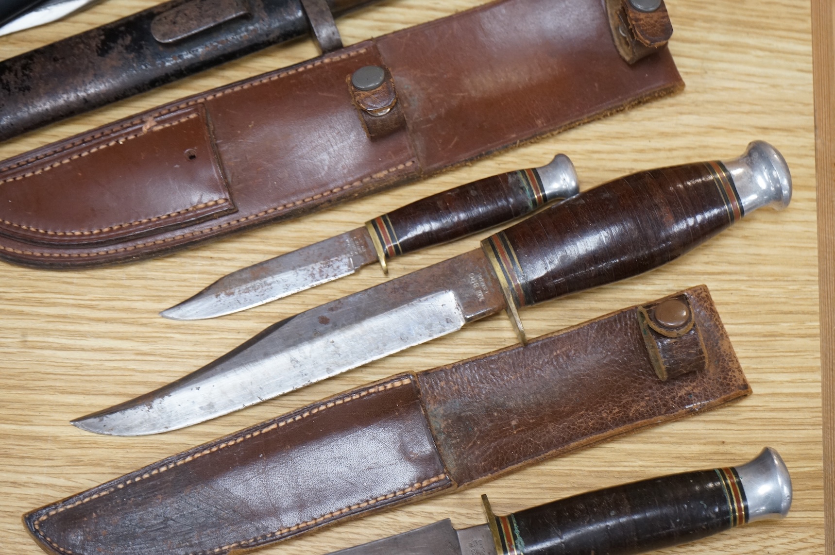 A 1907 bayonet by Wilkinson in its steel mounted leather scabbard, another similar with leather frog, two small British bayonets, a Continental bayonet, and two assorted hunting knives (7)